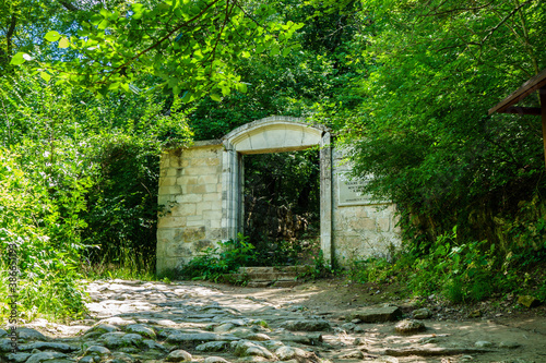 Main gates of medieval cemetery, Bakhchysarai, Crimea. There's seen part of writing in Russian (translates as 'Holy shrine of Dervishes & Muslim cemetery XV-XIX AD'). Located near fortress Chufut-Kale