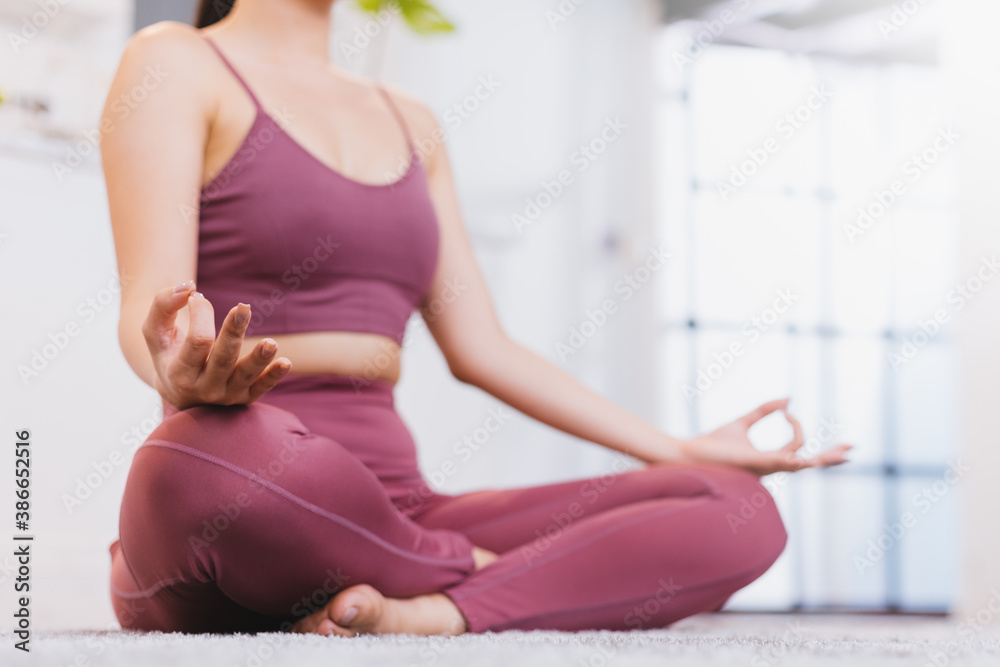 Close up hand woman sitting in Half Lotus exercise at home. Concept of healthy life and natural balance between body and mental development. Full length. Healthy and yoga concept.