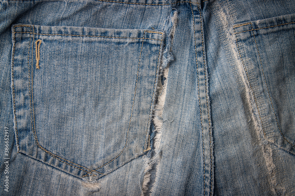 Detail,Texture of the old torn blue jeans. Detail,Texture of the old torn blue jeans.