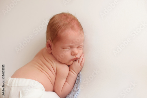 portrait of a little infant newborn baby: baby's face close-up. concept of childhood, healthcare, IVF 