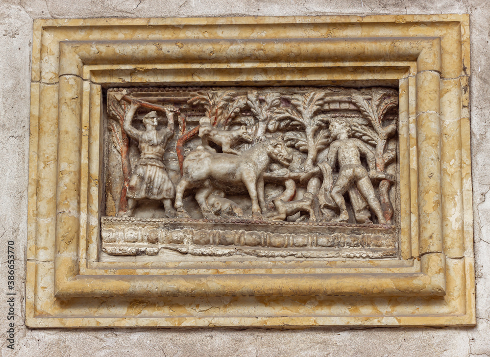 Stone bas-relief on the wall at the exposition in the courtyard of the Museo Lapidario Maffeiano in Verona, Italy