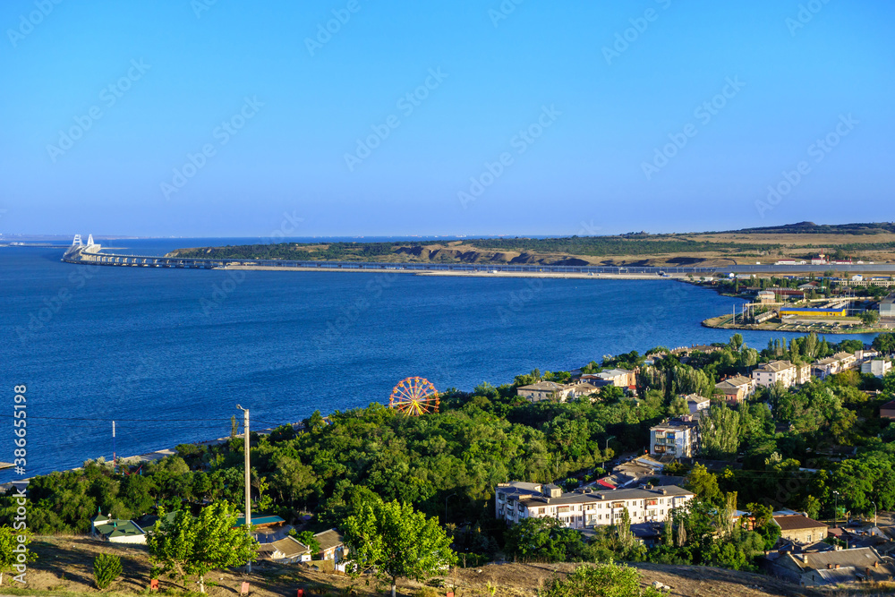 Panorama of Kerch, Crimea. There are park of attractions & residential houses. Crimean bridge & railroad are on background