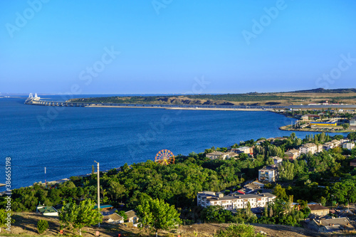 Panorama of Kerch, Crimea. There are park of attractions & residential houses. Crimean bridge & railroad are on background © Poliorketes