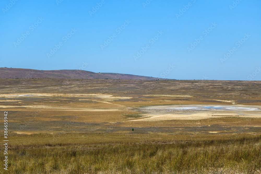 Panorama of Bulganak field of mud volcanoes near by Kerch, Crimea. Right side is mud sopka (or hill) called Central Lake, diameter about 110 feet. Some volcanos on left side. All of them are acting