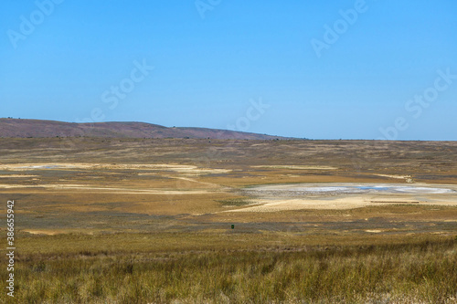 Panorama of Bulganak field of mud volcanoes near by Kerch, Crimea. Right side is mud sopka (or hill) called Central Lake, diameter about 110 feet. Some volcanos on left side. All of them are acting