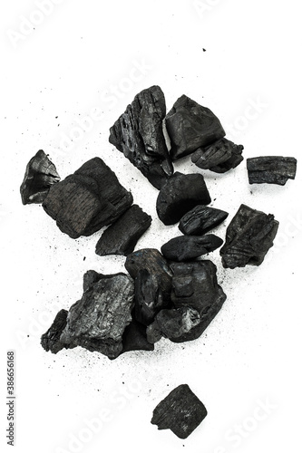 Many pieces of black charcoal isolated on white background.