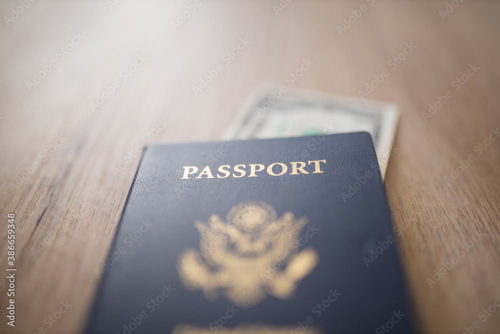 United States of America Passport with a Blurry One-Dollar Bill Inside United States of America Passport with a Blurry One-Dollar Bill Inside