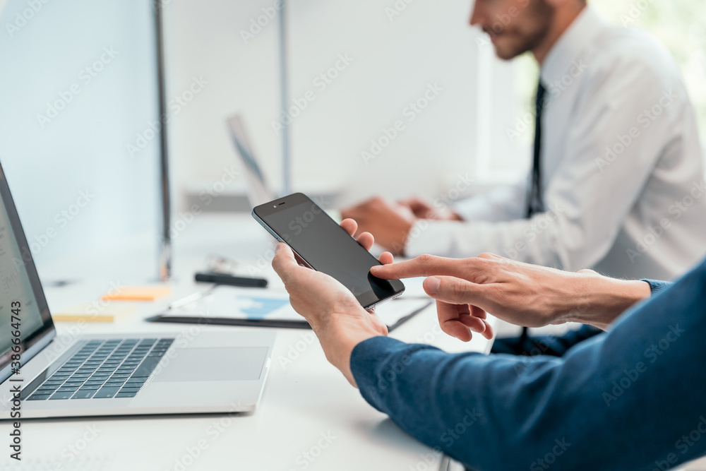 close up. businessman using his smartphone in the office .