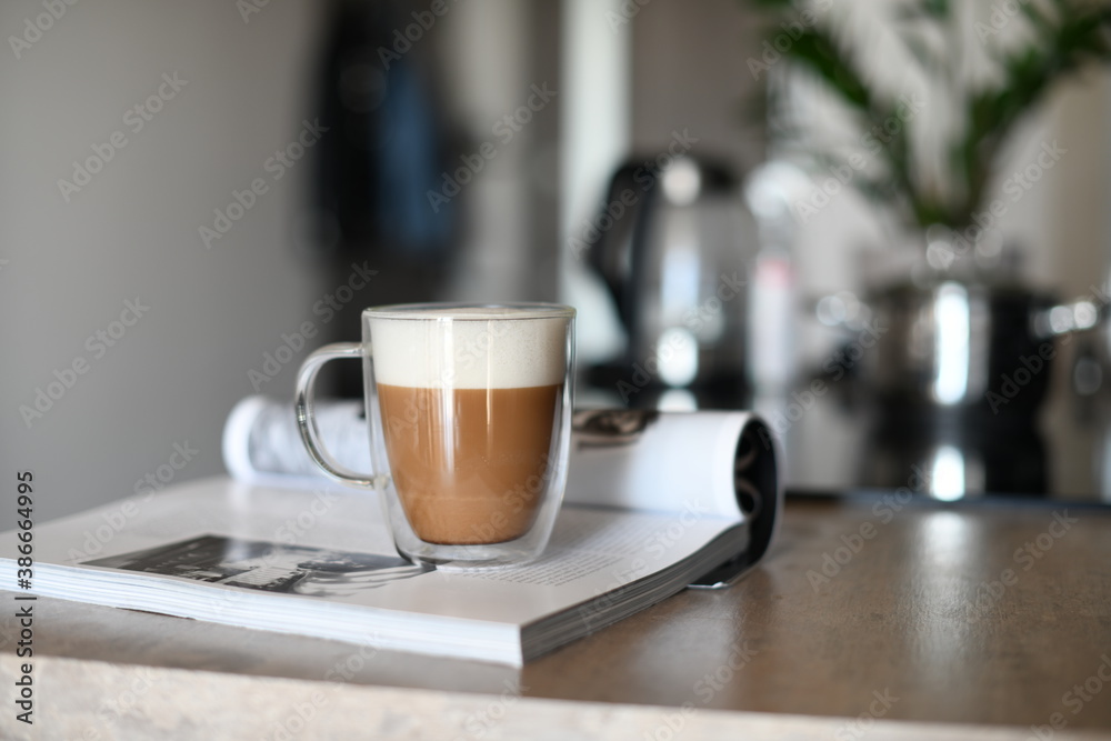 Transparent glass coffee cup on wooden kitchen table Transparent glass coffee cup on wooden kitchen table
