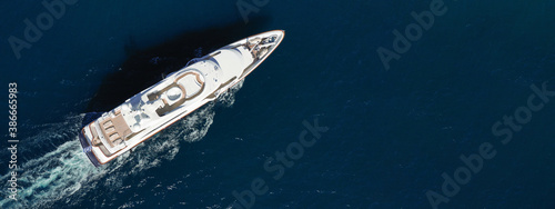 Aerial drone ultra wide photo of luxury yacht with wooden deck cruising in Aegean deep blue sea © aerial-drone