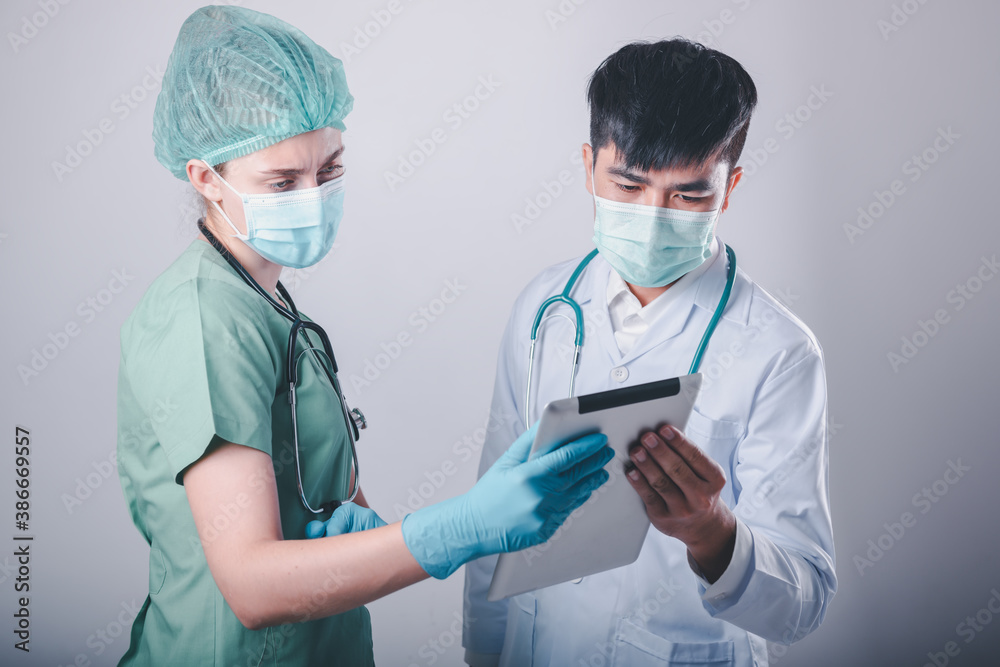 Doctor Team Discussion Patient Diagnosis Report on Tablet Against Patients Ward Background, Group of Doctors Teamwork in Medical Equipment Working in Clinic Surgical Hospital. Healthcare/Medicine Doctor Team Discussion Patient Diagnosis Report on Tablet Against Patients Ward Background, Group of Doctors Teamwork in Medical Equipment Working in Clinic Surgical Hospital. Healthcare/Medicine