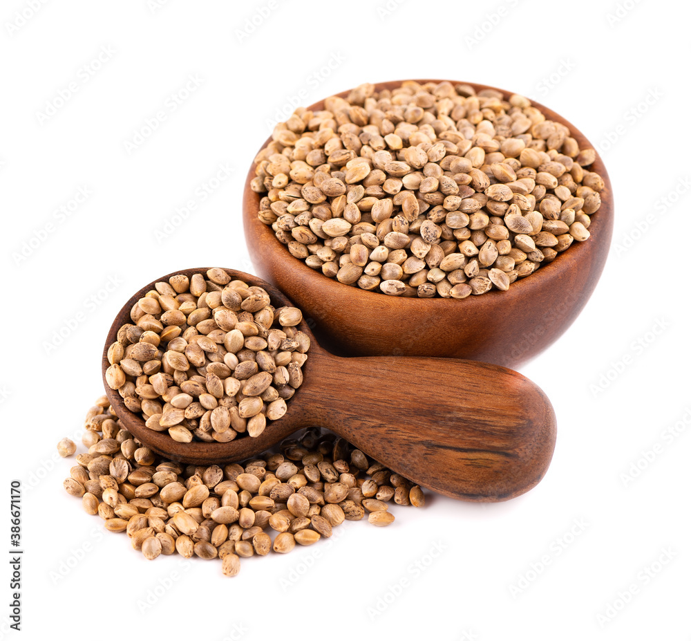 Hemp seeds isolated on white background. Dry seeds of cannabis, hemp or marijuana in wooden bowl and spoon. Hemp seeds isolated on white background. Dry seeds of cannabis, hemp or marijuana in wooden bowl and spoon.