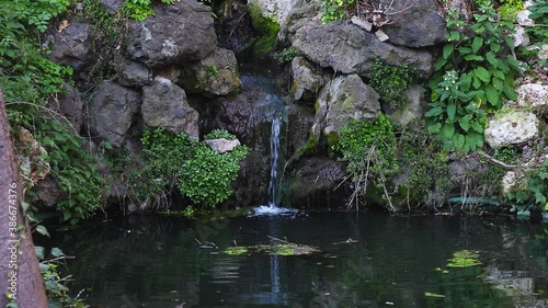 Beautiful landscape natural textures on the blue clear sky, water flowing through rocks in nature garden wallpaper background