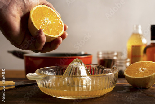 Juicing an orange for a mulled apple cider and orange cocktail. photo