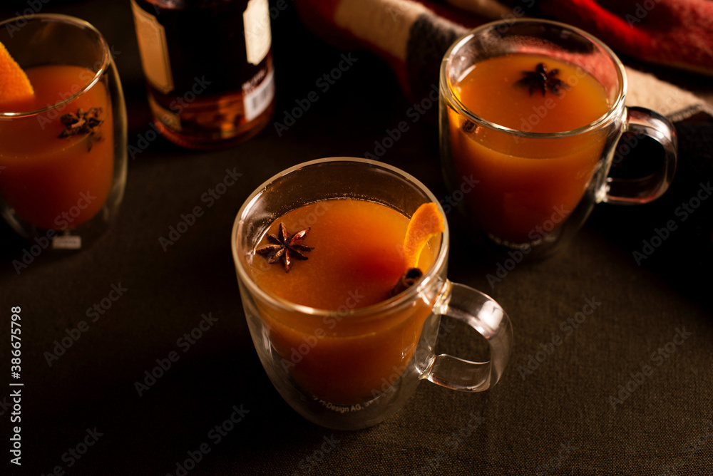Mulled apple cider and orange cocktails. Mulled apple cider and orange cocktails.