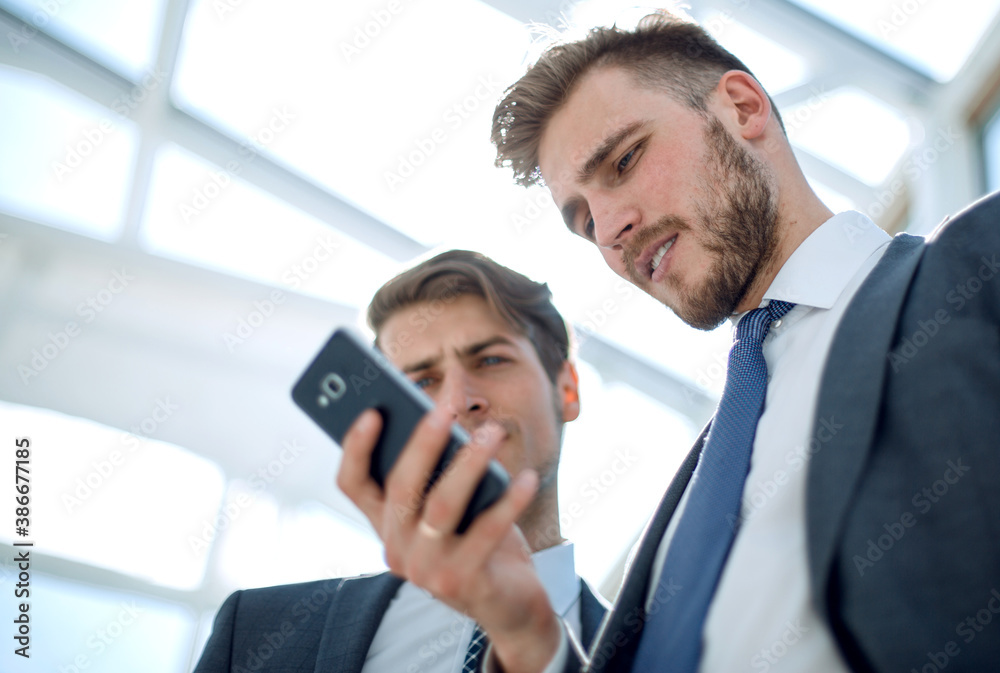 close up.business colleagues looking at the smartphone screen. close up.business colleagues looking at the smartphone screen.