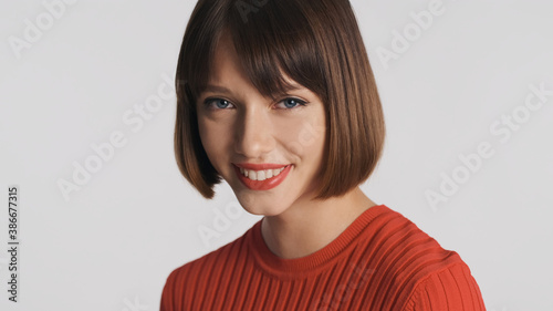 Wallpaper Mural Pretty girl with bob hair and red lips look charming over white background. Cute expression Torontodigital.ca