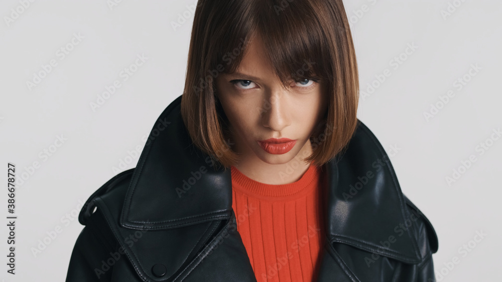 Beautiful girl with bob hair and red lips posing on camera with devil look isolated Beautiful girl with bob hair and red lips posing on camera with devil look isolated