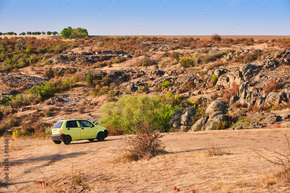 Green car on the background of the hills of the Canyon