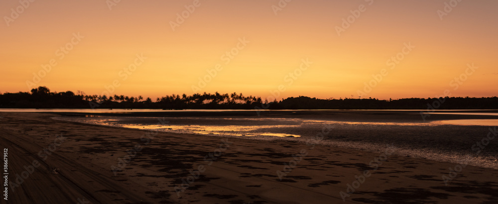 Panorama of a sand beach during low tide and sunset near Ngwesaung, Myanmar Panorama of a sand beach during low tide and sunset near Ngwesaung, Myanmar