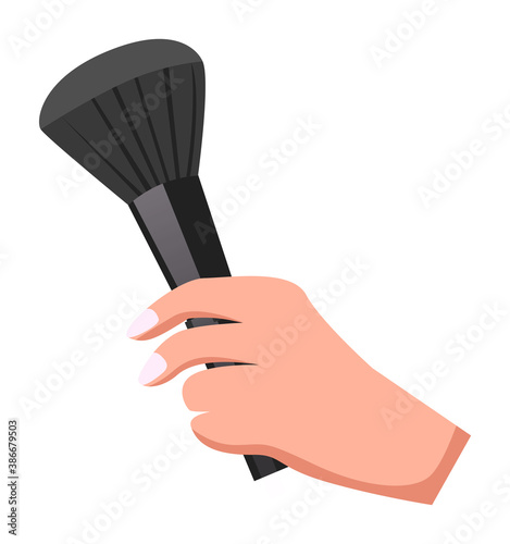 Female hand with manicure holding makeup brush. Black brush for powder. Cosmetic tool or instrument for visagiste. Isolated woman hand holding cosmetical product or accessory. Makeup fashion design