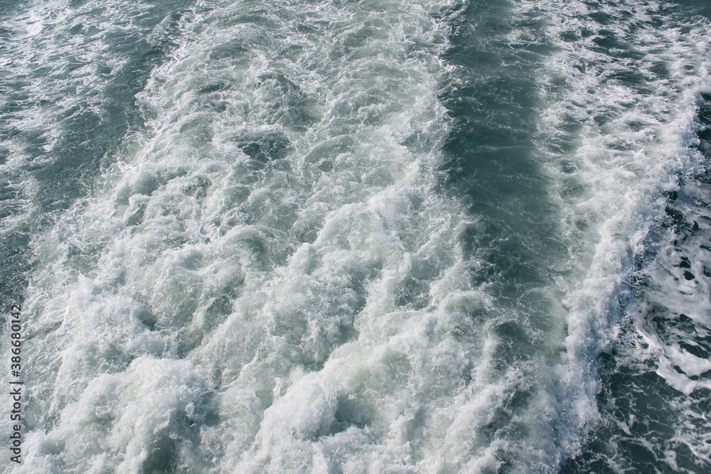 Frothy trail behind the boat on the ocean.