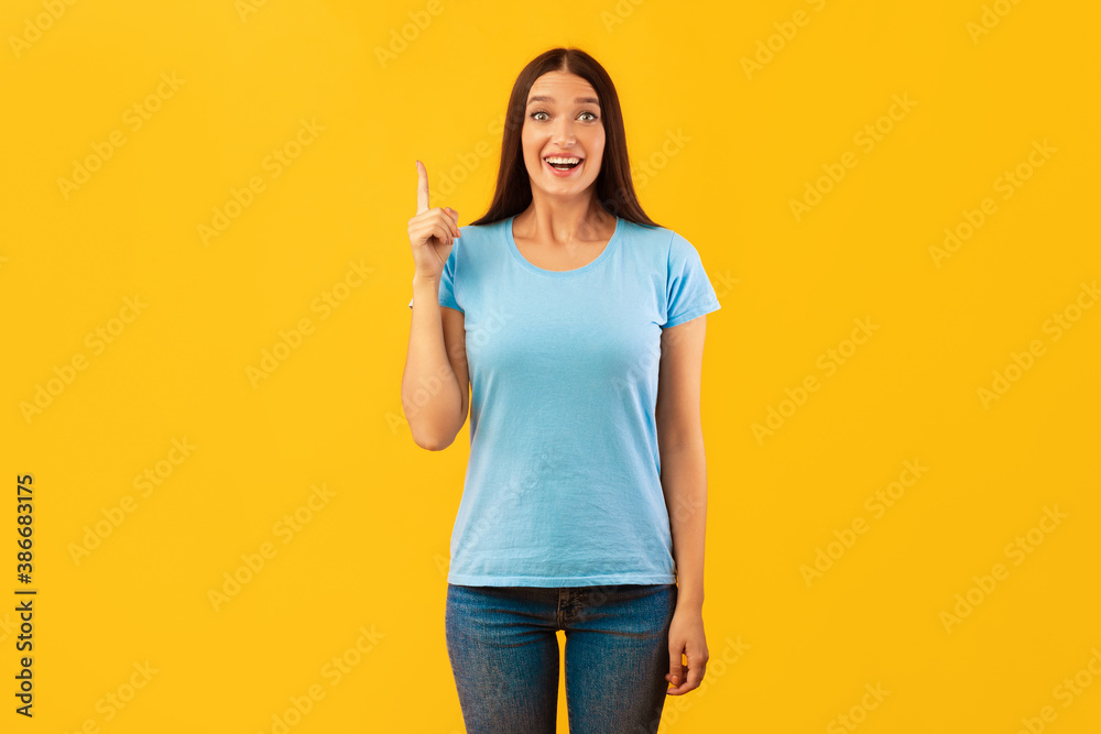 Excited woman having great idea and pointing up Excited woman having great idea and pointing up