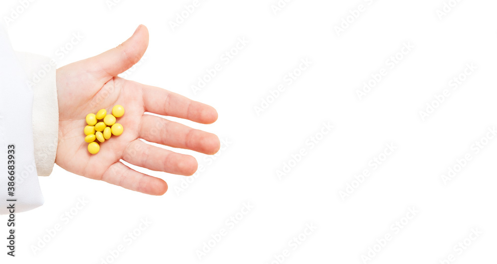 medicines on baby hand, yellow pills, small drug.