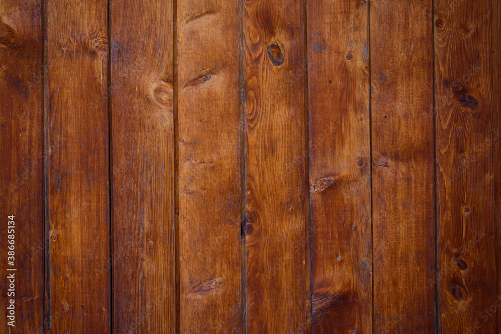 Old wooden background, close-up. Brown vertical boards. Facing the exterior walls of the house. Old wooden background, close-up. Brown vertical boards. Facing the exterior walls of the house.