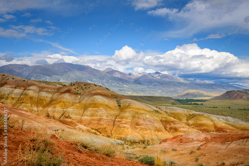 Natural attraction of Altai mountains, Martian landscapes. Stunning panorama with a ridge of rocks against a blue sky with white clouds. Popular tourist routes in Russia.