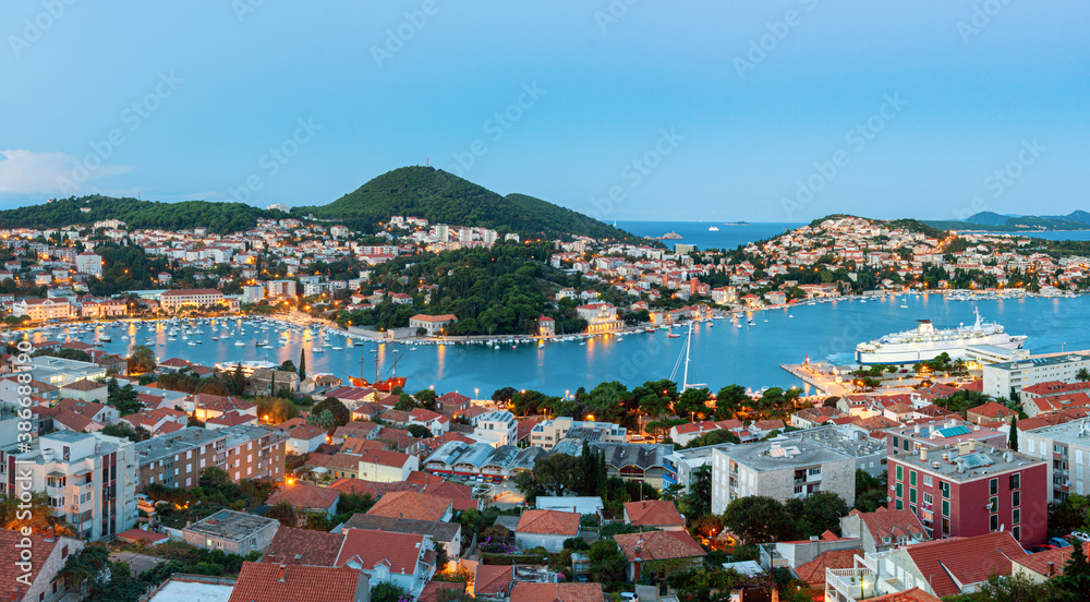 View of Gruz neighborhood and the lapad peninsular of Dubrovnik during sunrise with the Adriatic sea in the background. Croatia. View of Gruz neighborhood and the lapad peninsular of Dubrovnik during sunrise with the Adriatic sea in the background. Croatia.