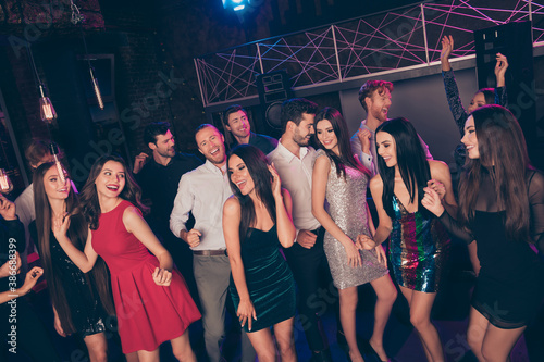 Nice attractive elegant cheerful friends dancing having fun visiting concert corporate event dark night club indoors