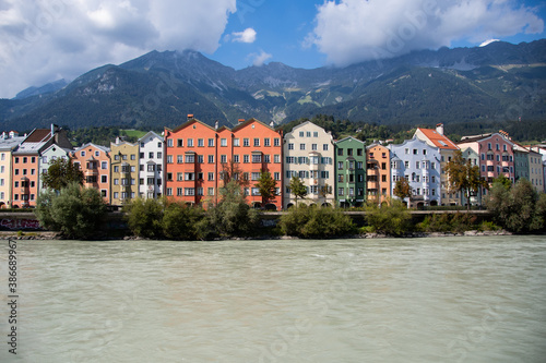 Colorful apartment buildings in Innsbruck with the river Inn and mountains in the background © David