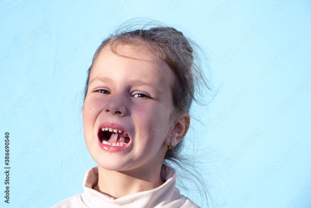 A five-year-old girl does an exercise to stretch her tongue. These are speech therapy classes A five-year-old girl does an exercise to stretch her tongue. These are speech therapy classes