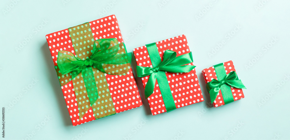 Top view Christmas present box with green bow on blue background Top view Christmas present box with green bow on blue background