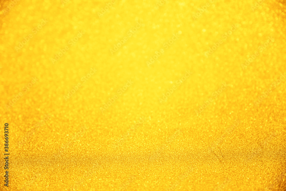 Obraz premium Luxury gold glitter texture with bokeh as background, de-focused. concept for studio backdrop , chrismas , holiday , happy new year , decoration.