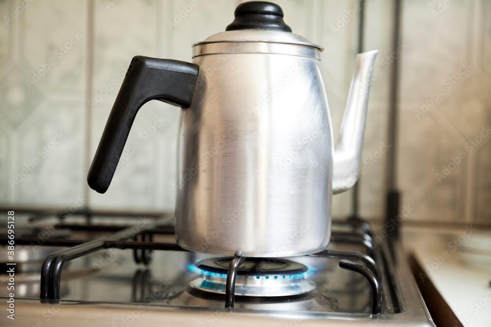 Coffee pot being heated on a residential stove over a low flame in a Brazilian house. Textured tile background in Brazilian cuisine. Copy space. Drink concept. Coffee concept.
Coffee pot being heated on a residential stove over a low flame in a Brazilian house. Textured tile background in Brazilian cuisine. Copy space. Drink concept. Coffee concept.