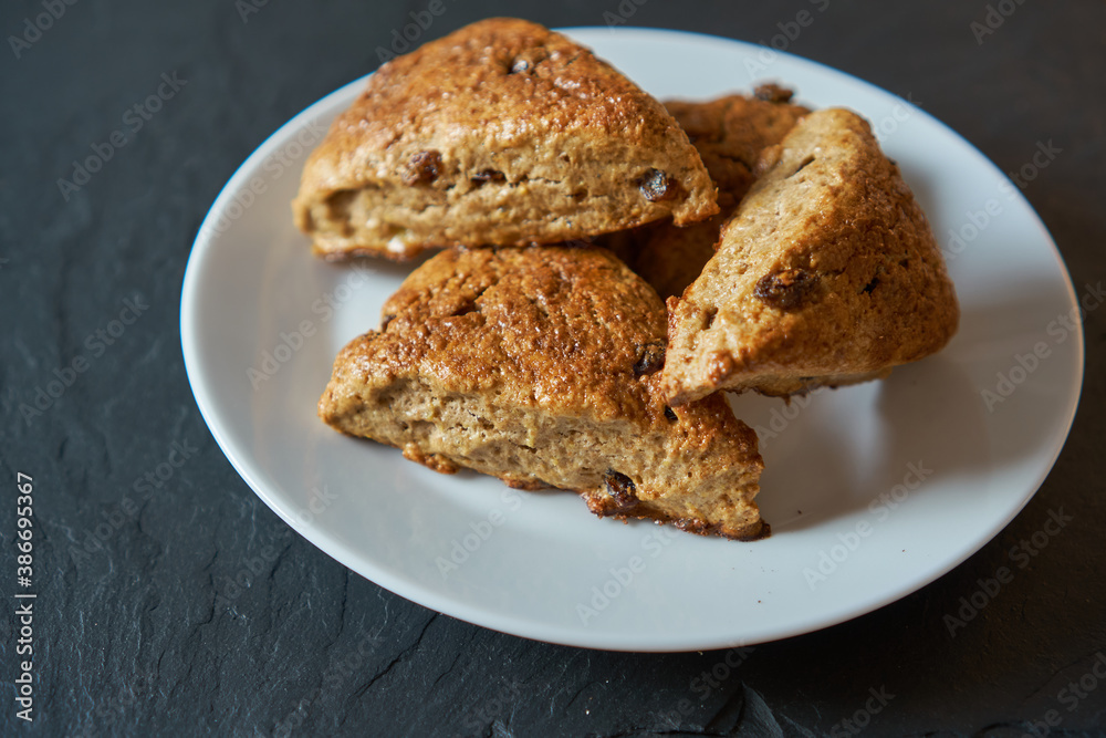 Traditional fresh baked English homemade scones with raisins for breakfast.  