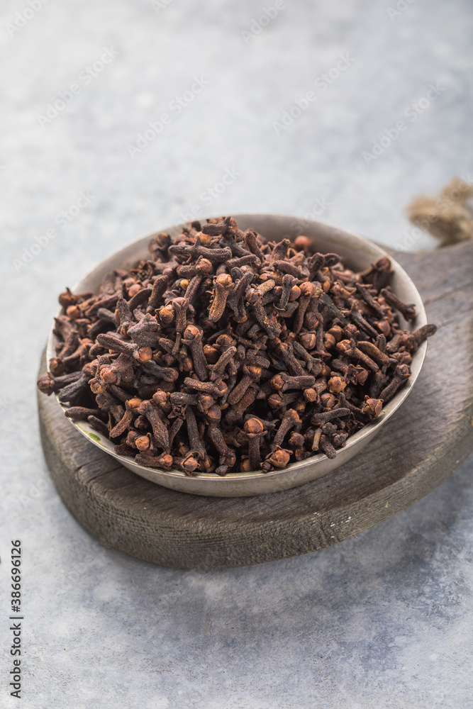 Spice dry cloves on stone background with copy space Spice dry cloves on stone background with copy space
