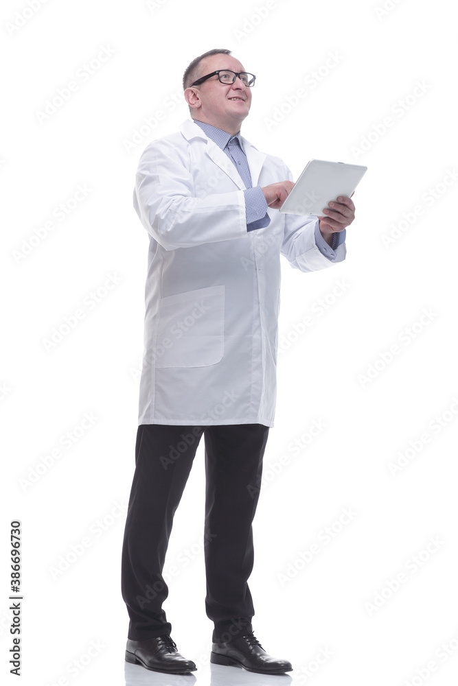 in full growth. a competent mature doctor with a digital tablet. in full growth. a competent mature doctor with a digital tablet.