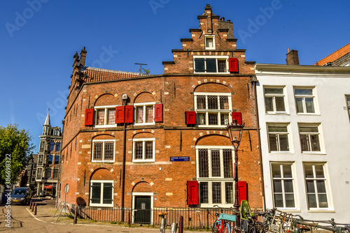 Photography Historic building with stepped gable at the Sleutelbrug on the Oudezijds Achterburgwal in Amsterdam, the Netherlands