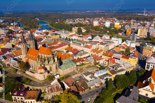 Aerial view of medieval Gothic Cathedral of St. Bartholomew on background with Kolin cityscape on sunny autumn day, Czech Republic ..