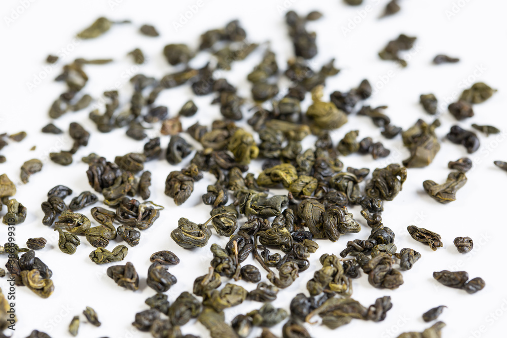 Green tea, on a white background, tea scattered on a white background. Green tea, on a white background, tea scattered on a white background.