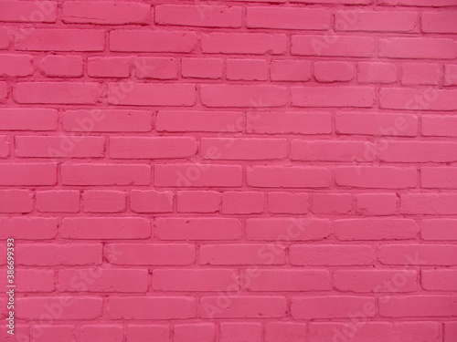 Brick wall texture, pink background with copy space