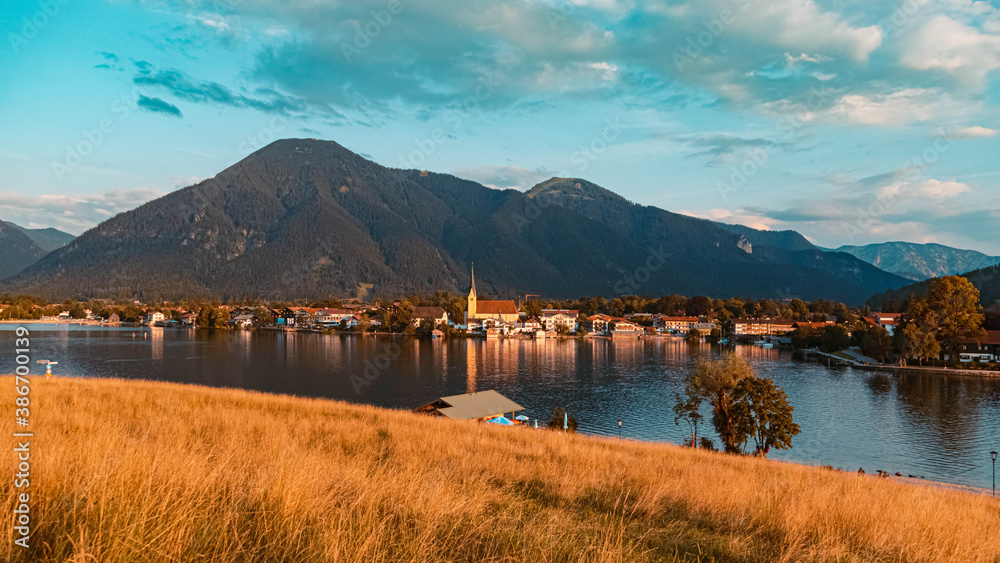 Beautiful alpine summer evening view with reflections and Rottach-Egern in the background at the famous Tegernsee, Bavaria, Germany
