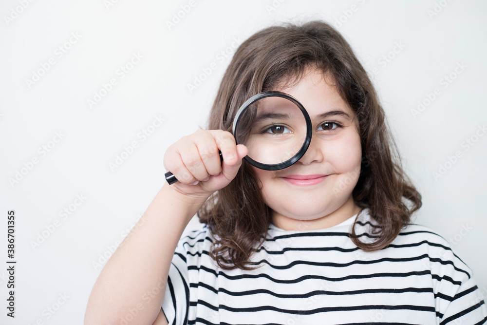 little girl looking with a magnifying glass little girl looking with a magnifying glass