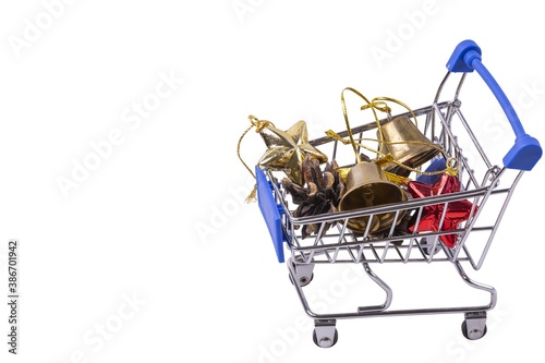 View of colorful christmas decorations in toy shopping cart on white background. Christmas background.