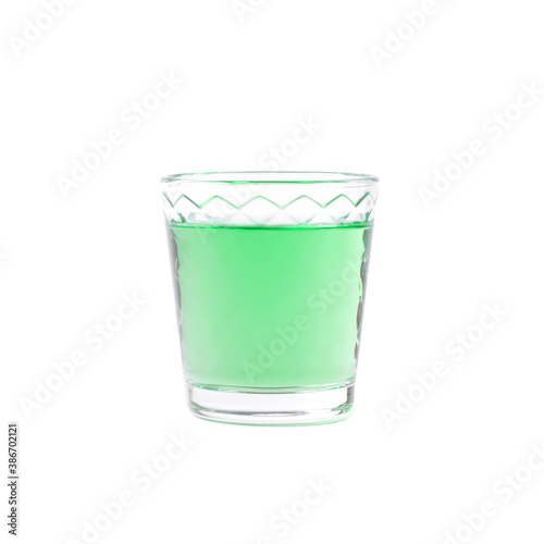 Green liquor in a shot glass isolated on white