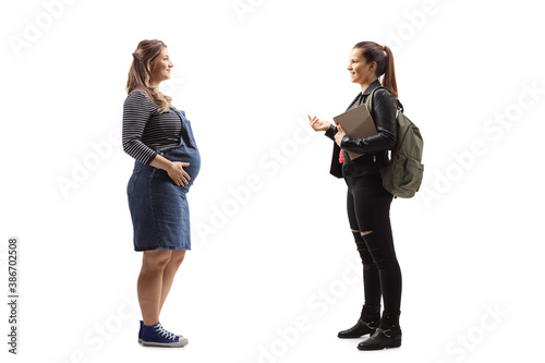 Full length profile shot of a female student talking to a pregnant woman