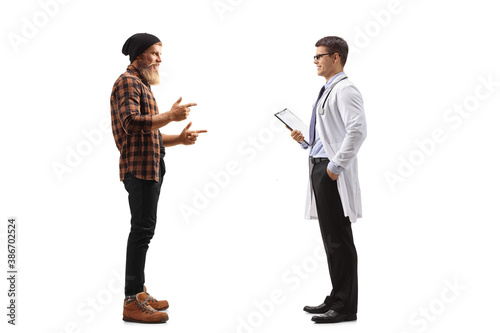 Full length profile shot of a bearded guy standing and talking to a male doctor